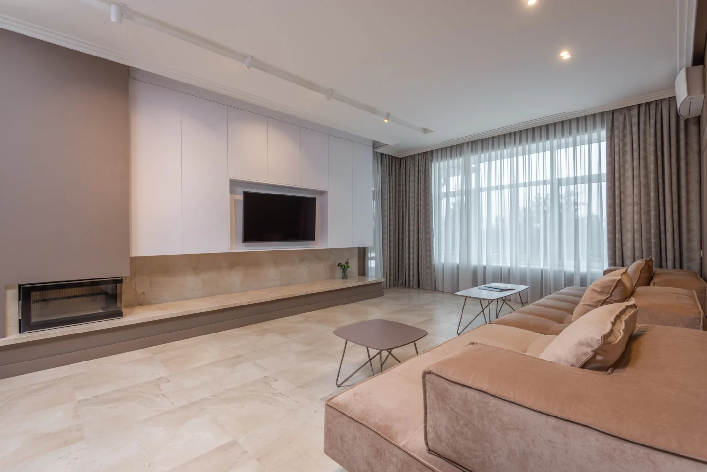 A living room with large windows and calm neutral tones (illustrative)