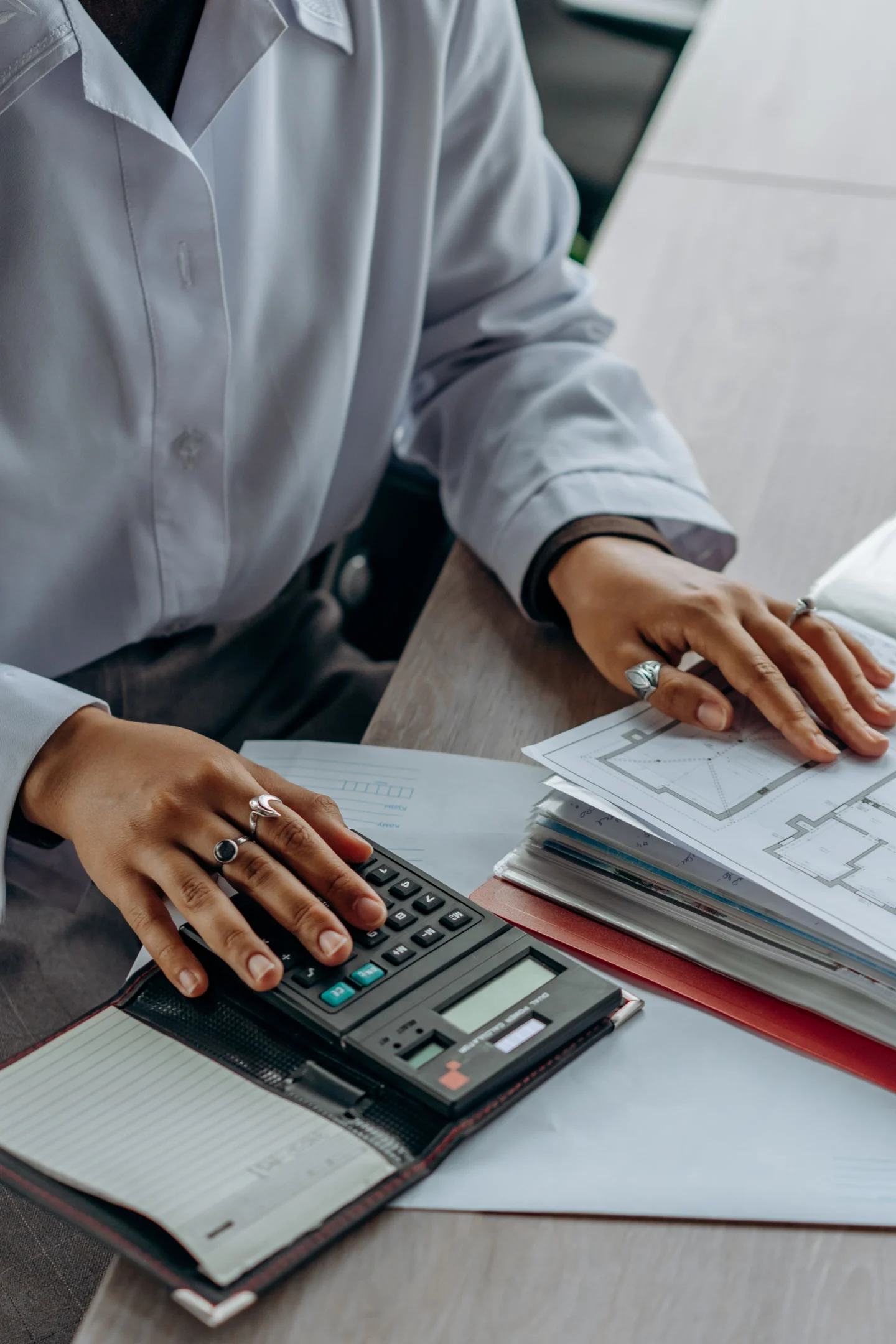 Reviewing figures using a calculator and documents (illustrative)