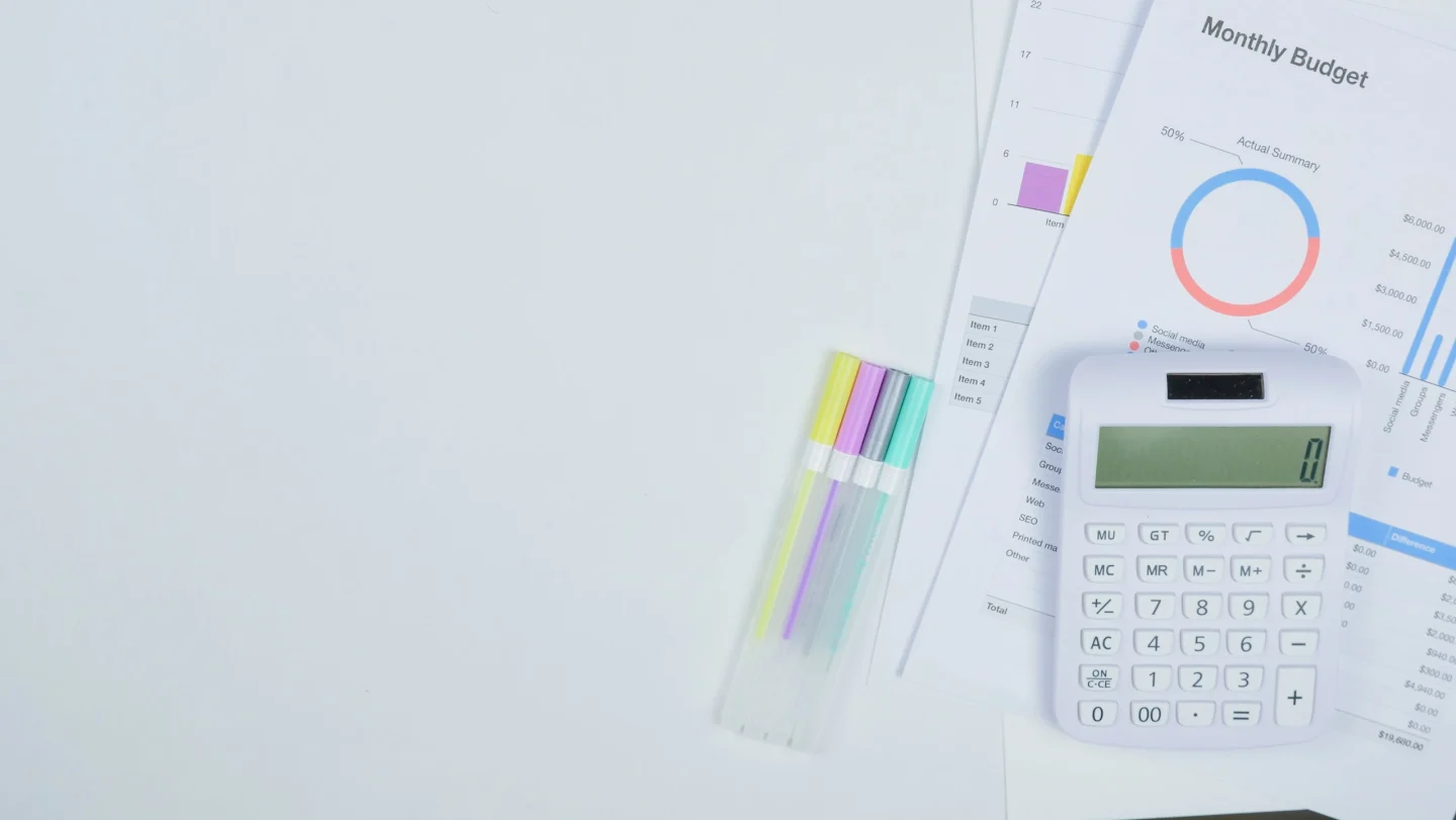 A calculator and budget-planning papers (illustrative)
